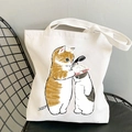White canvas tote bag featuring cute cartoon cats bathing print on a black chair - Cats Bathing