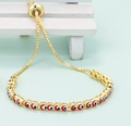 Adjustable golden bracelet with colorful red, black and white evil eye enamel patterns - Red