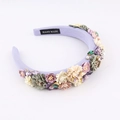 Detail of handmade purple sponge headband featuring fabric flowers and inlaid gemstones - Purple