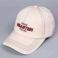 Detailed macro view of the contrast stitching and red embroidered lettering on the cap - M (56-58cm) / Beige