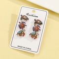 Detailed view of bohemian turtle stud earring set with colorful ethnic patterns on white card - Sea Turtle Set (N-339)