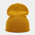 Detailed view of the ginger yellow knitted beanie showing vertical ribbed texture and fabric - Ginger Yellow
