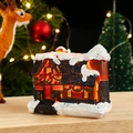 Close-up of lighted resin Christmas house with snow decor and festive wreaths - Brown Wall Snow House (Style 23 Medium A)