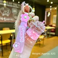 Close-up of pink Sakura liquid acrylic keychain with sequins and dry flowers on a hand - Cherry Blossom Rope [pink] Glow-in-the-dark Dried Flower Iceberg Cup