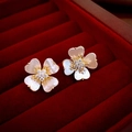 Macro shot of gold four-leaf clover earrings with white shell petals and diamond center - Gold Flower (66# Silver Earring Post)