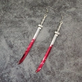 Detail of silver katana sword earrings with red blood stains and gothic metal finish - Katana Sword