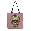 Detail of pink canvas tote bag featuring a vibrant sugar skull print and black straps - Light Pink Background Day of the Dead Sugar Skull (hm6651)