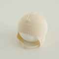 Detailed knit texture of a cream baby bonnet with moss stitch and smooth finish - 3-15 Months / Off-white