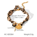 Macro detail of leopard print ribbon bracelet with sunflower pendant and size specs - Sunflower Flower Beaded Leopard Print Fabric Bracelet (HC-B20364)