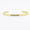 Minimalist 4mm gold-plated stainless steel cuff bracelet engraved with FEARLESS text - FEARLESS.
