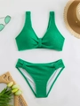 Detailed flat lay of green textured bikini set with bubble fabric and stylish holiday props - Green