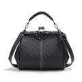 Close-up of a vintage black woven PU leather doctor bag with a floral engraved metal clasp - Black