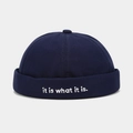 Detail of dark blue canvas docker hat featuring white embroidered it is what it is quote - Adjustable / Navy Blue