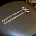 Close-up of silver tassel earrings with crystal-encrusted hoops on a grey surface - Long Tassel (28#)