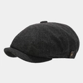 Close-up of herringbone newsboy cap with leather side tag and bronze metal buckle - One Size / Black