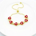 Detail of gold adjustable bracelet with red enamel hearts and evil eye charms - Red