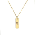 Close-up of gold-plated pendant featuring letter Q encrusted with colorful diamonds - Letter Q