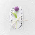 Detailed close-up of handmade purple knitted tulip with green leaves and silk ribbon - Bulb Tulip - Dark Purple