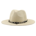 Close-up of woven straw hat with feather detail and decorative strap on a white background - Beige