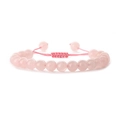 Pink quartz beaded bracelet with handmade woven adjustable rope on white background - Rose Quartz