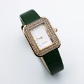 Detail of square gold watch face with crystal rhinestones and green leather strap - Green