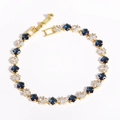 Detailed macro view of 18k gold-plated chain bracelet with square zircon inlays - 4mm Green Royal Blue Gold