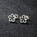 Polished silver stainless steel hollow flower stud earrings on a dark textured background - Five-Petal Flower / Steel