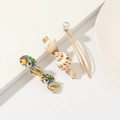 Detailed shot of three golden hair clips with natural shells, pearls and colorful prints - Printed Conch Pearl 3-Piece Fringe Clip Set