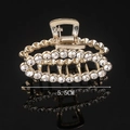 Detail of 5.5cm gold-plated hair claw with shimmering rhinestones on black background - Full Rhinestone Oval 5.5CM Claw Clip