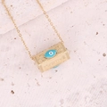 Macro shot of gold cylinder pendant with blue evil eye and Positive engraving - Blue Evil Eye POSITIVE Letter Cylinder Style (16#)