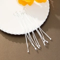Dettaglio di braccialetti intrecciati bianchi regolabili su un piatto decorato con fiori - 5 Pezzi / Bianco