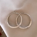 Minimalist silver hoop earrings on beige silk fabric background with professional lighting - Minimalist Smooth Hoop / 4# Silver Needle Round Hoop Earrings