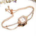 Close-up of square rose gold quartz watch with rhinestone bezel and dual chain bracelet - White Dial Rose Gold Strap