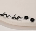Detailed macro view of minimalist black snake stud earrings with butterfly backs - 674 Black (Snake Wave)