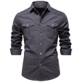 Detail of dark charcoal denim shirt showing buttoned chest pockets and rugged fabric texture - S / Dark Gray