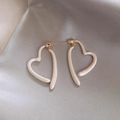 Minimalist heart-shaped pearl earrings with gold-tone finish on elegant silk fabric - Gold Cream White Heart