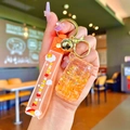 Detail of orange unicorn liquid quicksand keychain with soft strap and golden bell charm - Orange Luminous Bubble Bead Cola Can