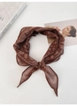 Detail of vintage bohemian printed silk scarf with paisley patterns and soft texture - Brown