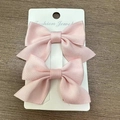 Pair of soft pink satin bow hair clips for girls displayed on a white jewelry card - Light Pink