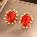 Macro shot of oval vintage earrings with red turquoise center and white pearl halo - E-340 / Gold Red Turquoise
