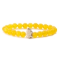 Detail shot of a stretch bracelet featuring yellow round beads and a white elephant charm - Yellow Chalcedony