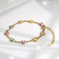 Detail of golden heart bracelet with multi-colored evil eye beads on white silk fabric - Multicolor Eye