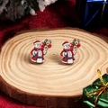 Festive Christmas snowman stud earrings displayed on a natural wood slice base - Colorful Snowman