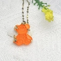 Gold necklace with orange resin bear pendant featuring star zircon inlays and water wave chain - Orange