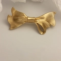 Elegant gold bow-shaped hair clip featuring a textured metallic finish and luxury design - Gold Ribbed Two-Way Bow Clip