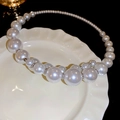 Macro view of gradient pearl necklace with silver spacers on a white ceramic tray - Choker Necklace / White