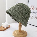 Close-up of army green hand-woven straw bucket hat with hollow-out crochet texture - Green