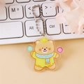 Mignon porte-clés ours en acrylique avec chapeau jaune et chaîne à billes argentée - Ours sucette