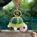 Handmade crochet green turtle keychain with pink shell and golden metal ring - Keychain Pendant / Green