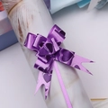 Detailed view of purple pull bow with heart pattern for festive gift wrapping - Purple Heart
